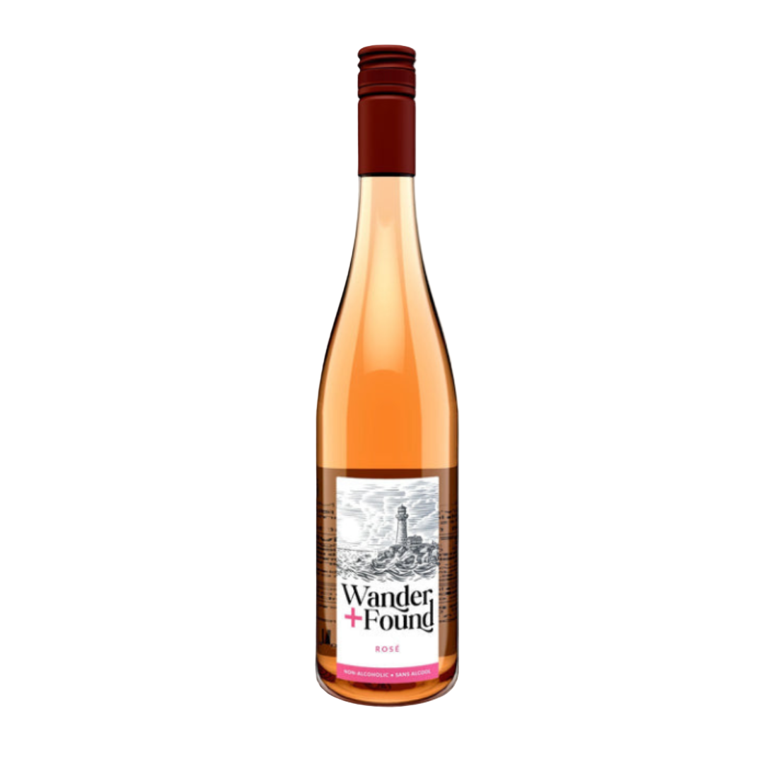 A bottle of Wander & Found nonalcoholic rosé wine on a wooden surface with a bright background.